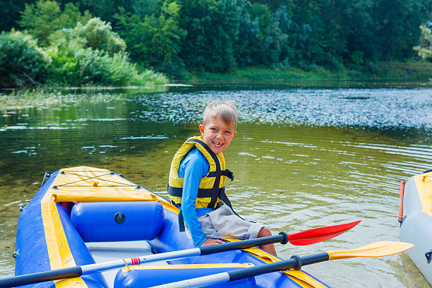 istock Happy boy kayaking on the river 521126408