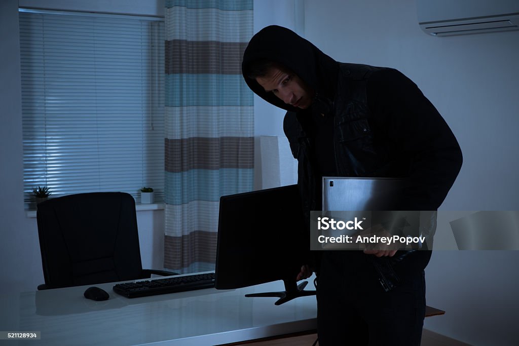 Thief Stealing Computer And Laptop Thief Stealing Computer And Laptop From Office Burglar Stock Photo