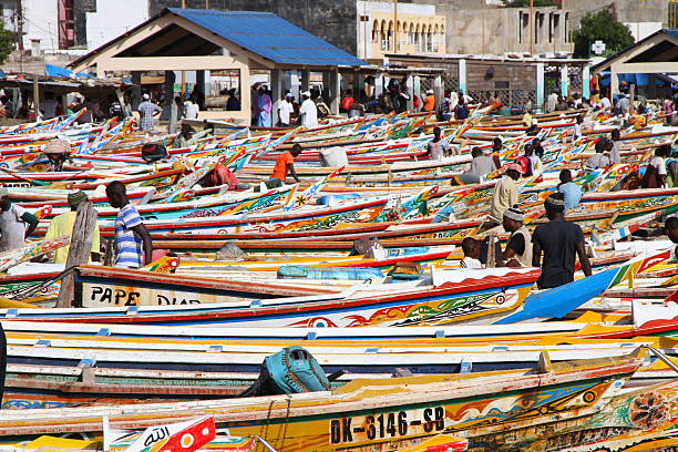 Soumbedioune fish market in Dakar, Senegal Dakar, Senegal - September 05, 2012: The Soumbedioune fish market in Dakar with the typical colourful fish-boat senegal photos stock pictures, royalty-free photos & images