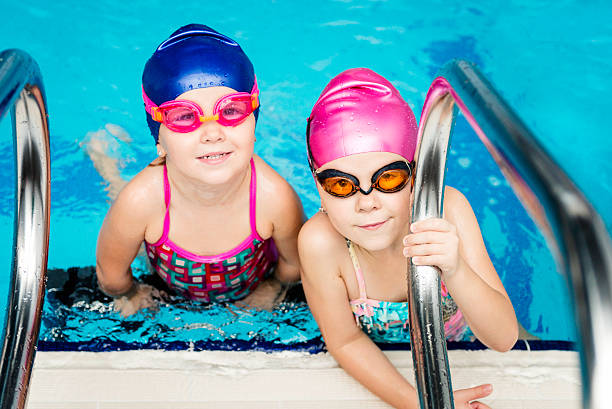 istock Little girls in swimming pool 521132163