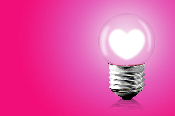 istock Heart glow inner electric lamp on pink background. 521132994