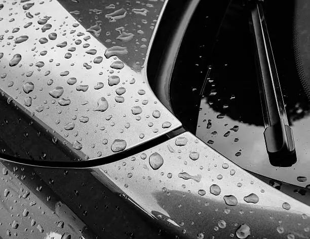 Water droplets on a car, after a heavy downpour, showing the beading effect of the water due to the car being waxed beforehand.