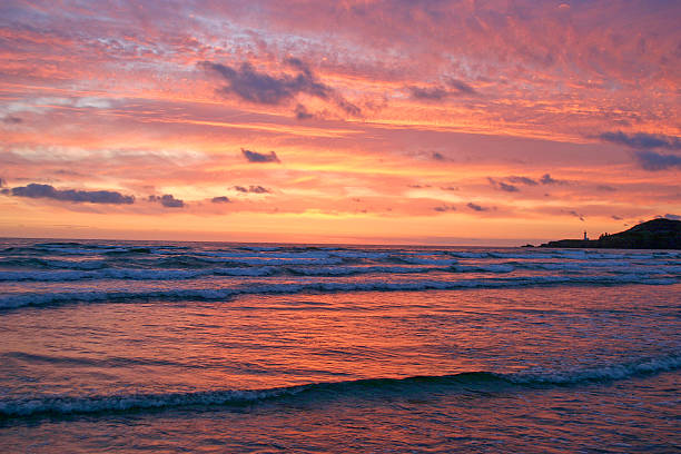 istock Brilliant Coastal Sunset With Distant Lighthouse 521133403