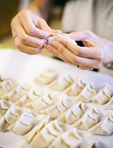 istock Japanese Woman Preparing Gyoza 521133525