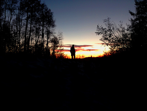 Silhouetted hunter against sunset in Colorado