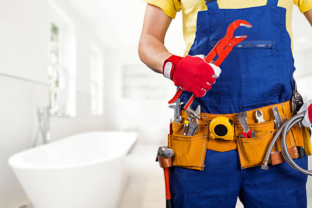 plumber with tool belt standing in bathroom plumber with tool belt and wrench in hand standing in bathroom bathroom work stock pictures, royalty-free photos & images