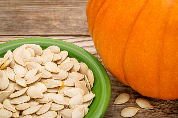 istock bowl of fresh pumpkin seeds 521135173