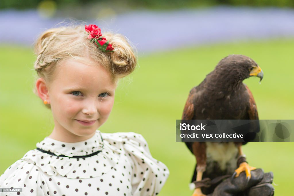 Cheecky girl with owl A blonde 2 year old girl with parasol; dressed in edwardian outfitA blonde 6 year old girl with parasol; dressed in edwardian outfitA 6 year old girl, dressed in edwardian style is posing with  a beautiful owl 2-3 Years Stock Photo