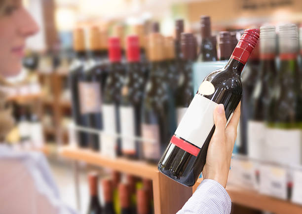 istock Woman holding wine bottle 521136597
