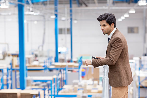 istock Businessman on factory balcony looking away 521136695
