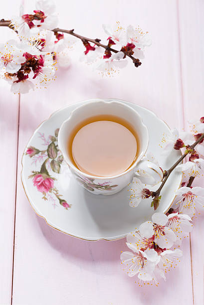 istock Cup of green tea and spring  flowers. 521138182