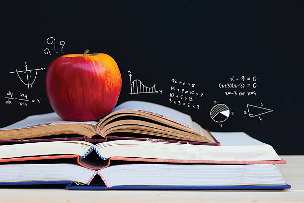 istock Apple on stack of open books with education doodles 521138474