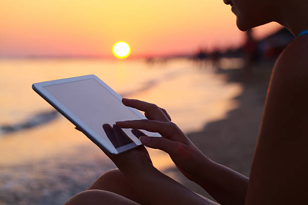 istock Woman using pad outdoor at sunset 521138529
