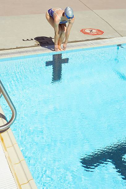 istock Woman ready to dive into swimming pool 521139060