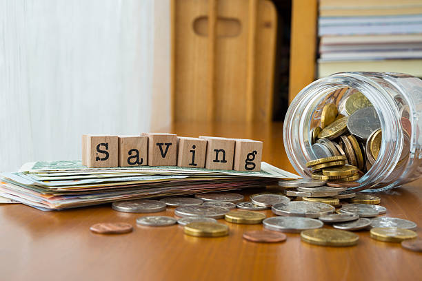 istock Money saving word with coins and banknotes 521139115