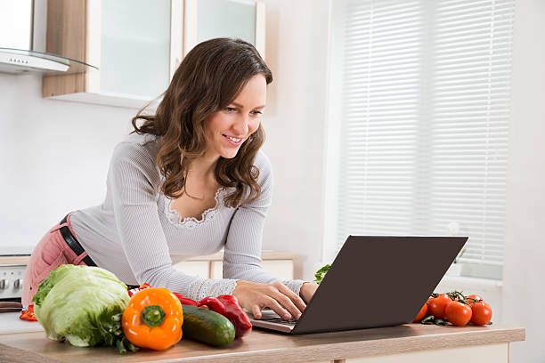 istock Woman Looking Recipe On Laptop 521139506