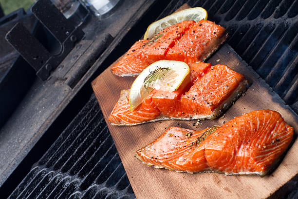 tre salmone alla griglia filets su cedar plank - lemon fruit portion citrus fruit foto e immagini stock