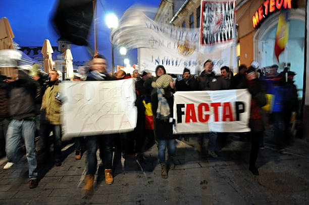 Citizens protesting against Romanian Government Cluj Napoca, Romania - February 11, 2012: Hundreds of people protesting against Acta, against web piracy treaty, and the government in Cluj Napoca ostentation stock pictures, royalty-free photos & images