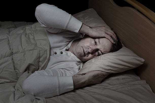 Man very sick in bed stock photo