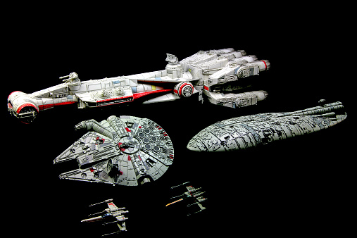 Vancouver, Canada - July 30, 2014: The Tantive IV Rebel Blockade Runner and a Rebel Blockade Runner, with the Millenium Falcon and X-Wings from the Star Wars movie franchise on a black background. The Tantive IV was the flagship of Princess Leia at the beginning of Star Wars, Episode IV: A New Hope. The models were made for the X-Wing minature game for Fantasy Flight Games.