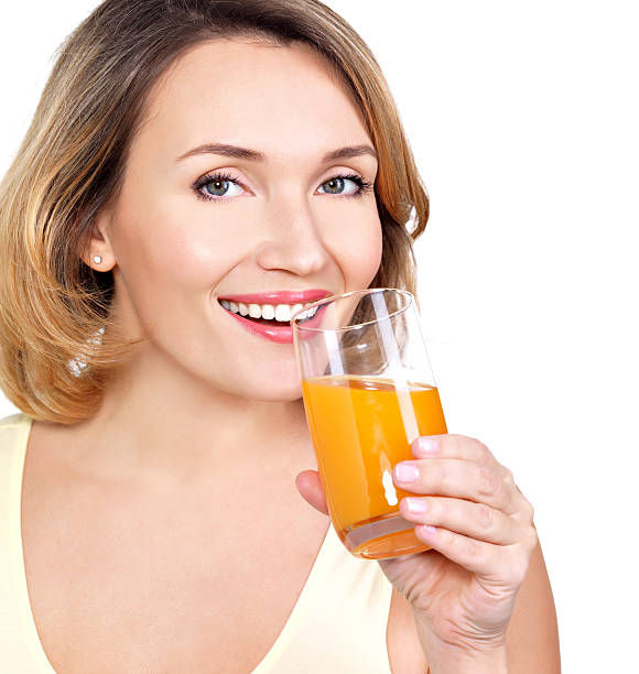 woman with a glass of orange juice