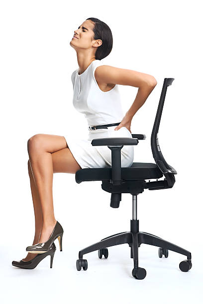 lower back pain Businesswoman with lower back pain from sitting on office chair woman sitting cross legged in chair stock pictures, royalty-free photos & images