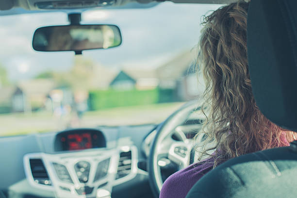 istock Young woman driving car 521180957