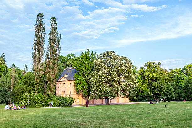 Weimar, Germany - May 27, 2012: people relax in the ilmpark in Weimar, Germany. The park was planned in 1776 under supervision of Johann Wolfgang Goethe. The style is similar to sentimental english  gardenparks.