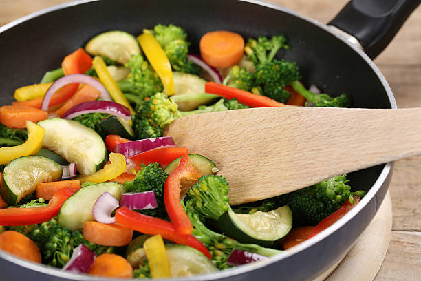 istock Preparing food vegetables in cooking pan with spatula 521184167