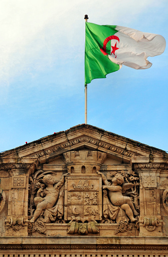Oran / Wahran, Algeria: Algerian flag flying over the City Hall - angels hold Oran's coat of arms - French colonial architecture - photo by M.Torres