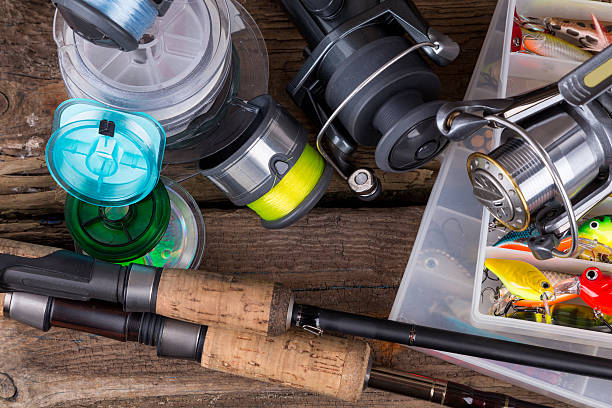istock fishing tackles on vertical wooden board background 521197386