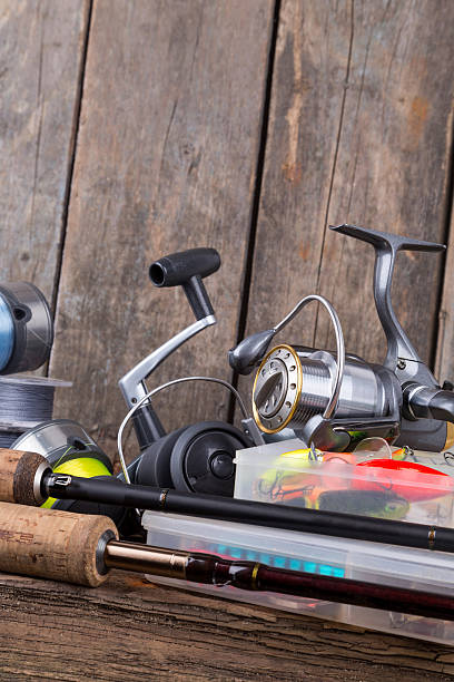 istock fishing tackles on vertical wooden board background 521197600