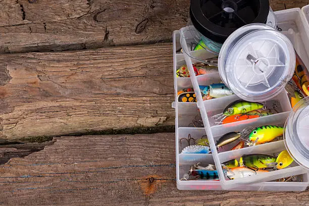 Photo of fishing tackles and fishing baits in box