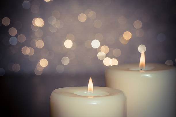 istock close-up of candles with flame on bokeh 521198048
