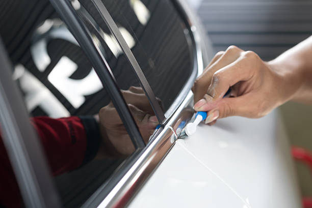 istock Car detailing series : Worker cleaning white car 521199400