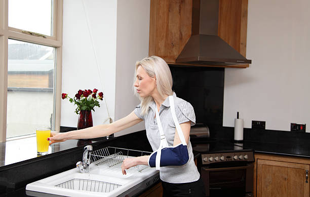 female in arm sling in kitchen