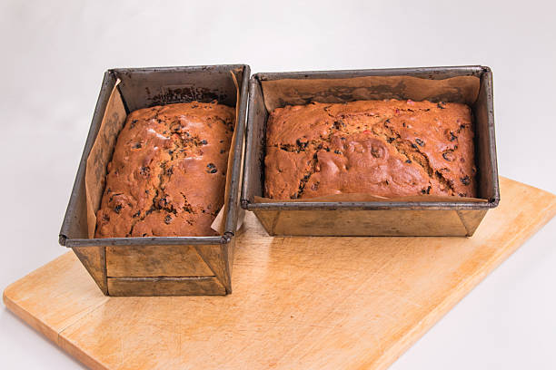 istock Making traditional fruit loaves, baked loaves in baking tins 521199501