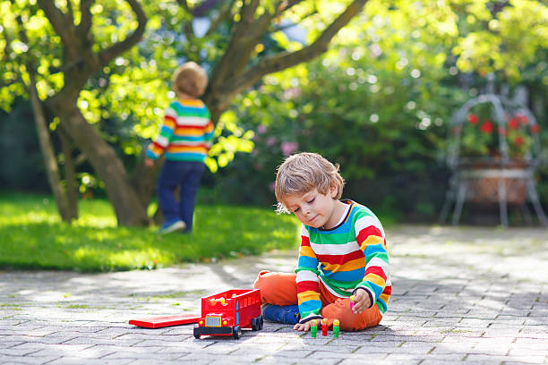 istock Little preschool boy playing with car toy 521199707