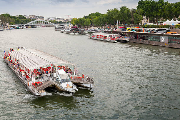 Paris, France - August 07, 2014: passenger touristic ship operated by Bateaux Parisiens sails on Seine river