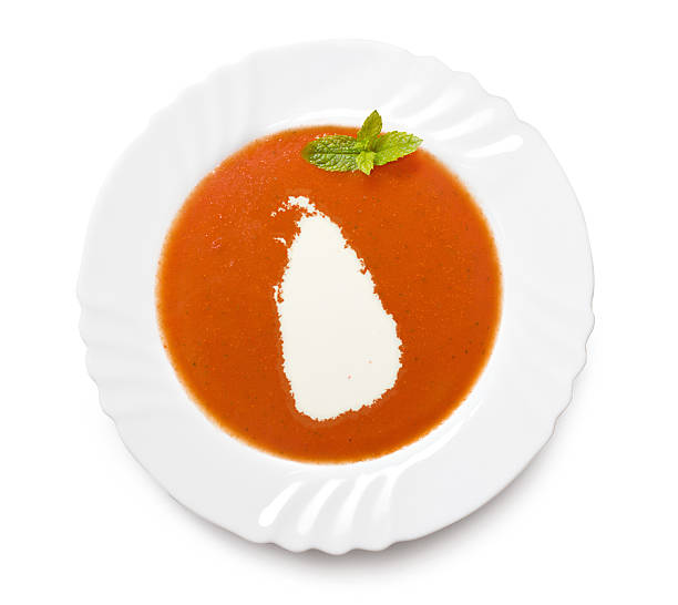 istock Plate with tomatosoup and cream (shape of Sri Lanka) 521200097