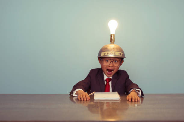 istock Surprised Japanese Business Boy Wearing Lit Up Thinking Cap 521200400
