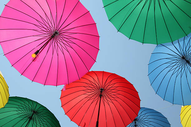 istock Collection of multi colored umbrellas hanging up. 521200757