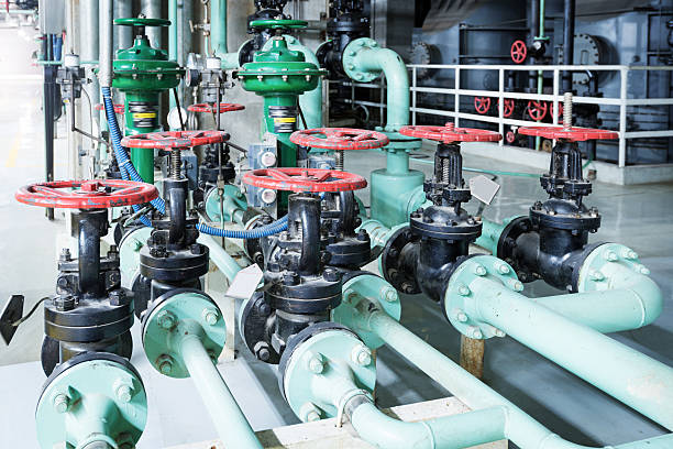 istock Equipment, cables and piping as found inside of industrial power 521202041