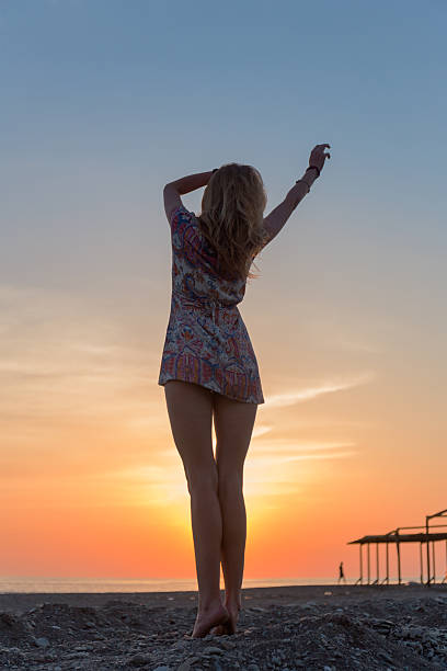 istock Beautiful young woman on the beach sunset 521203156
