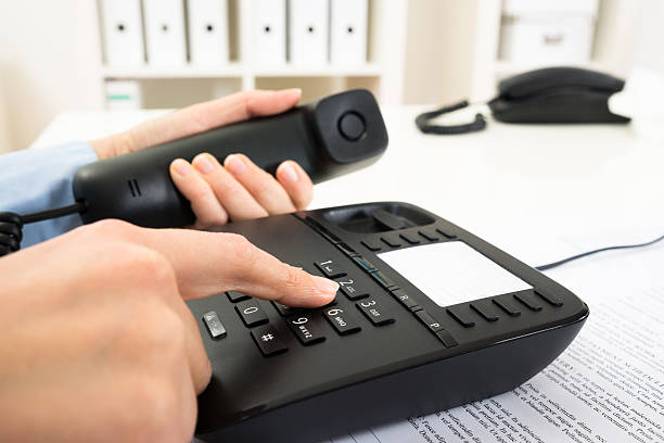 istock Businessperson Dialing Number On Telephone Keypad 521203352
