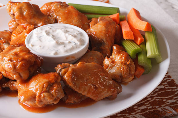 istock buffalo wings with cheese sauce and vegetables close-up. horizontal 521204018