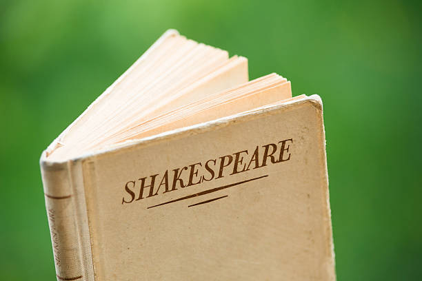 Book by Shakespeare Several Books by Shakespeare are Piled Up against a Natural Green BackgroundBook by Shakespeare against a Natural Green Background william shakespeare photos stock pictures, royalty-free photos & images