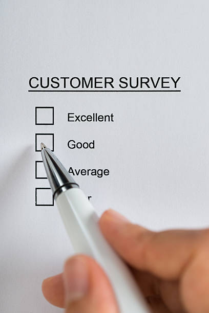 istock Person Hands Filling Customer Survey Form 521204388