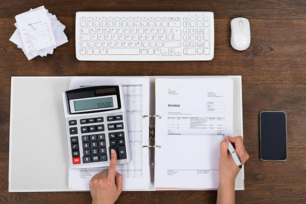 istock Person Calculating Invoice With Calculator 521204898