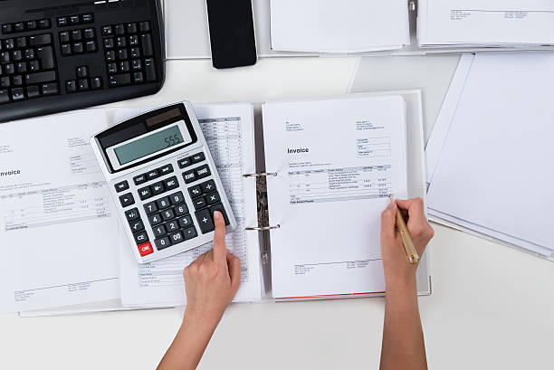 istock Person Calculating Receipts 521205060